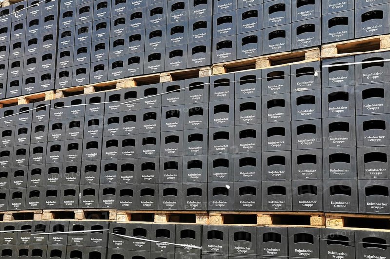 Stacked black beer crates from the Kulmbacher Group, a beverage manufacturer that includes Kulmbacher Brauerei AG and other breweries such as Sternquell, Braustolz and Würzburger Hofbräu, editorial