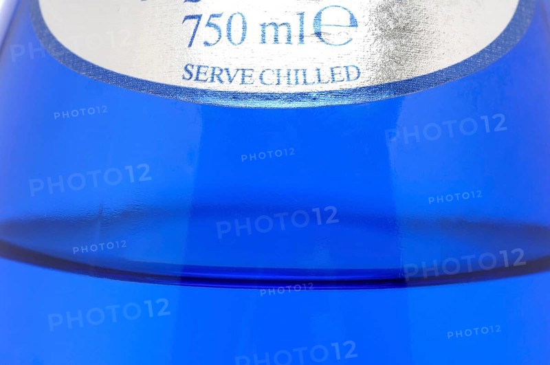 Glass with mineral water, small carbonated pearls on the edge of the glass, drinking water