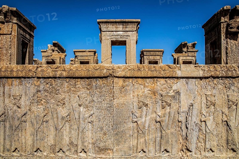 Persian wax soldiers on the western steps of the Darius Palace with cuneiform script, Persepolis