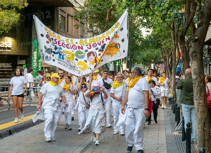 Evening procession through city streets by youth group organisation, Pilar 2025 festival event, Zaragoza, Aragon, Spain