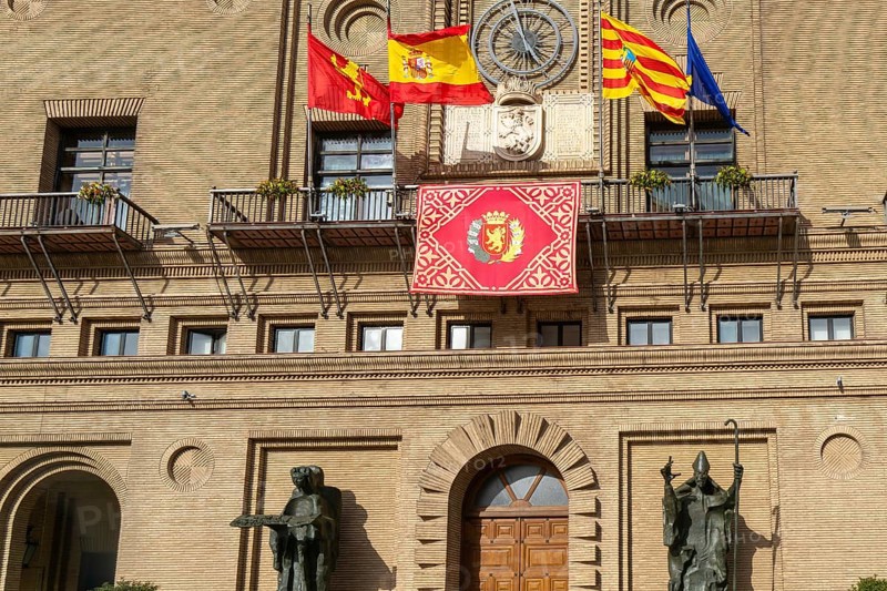 Flags flying Ayuntamiento city hall building, Plaza del Pilar, city centre of Zaragoza, Aragon, Spain