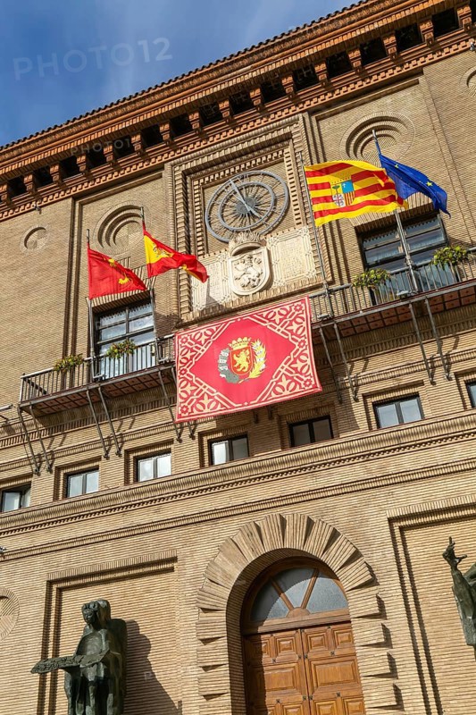 Flags flying Ayuntamiento city hall building, Plaza del Pilar, city centre of Zaragoza, Aragon, Spain