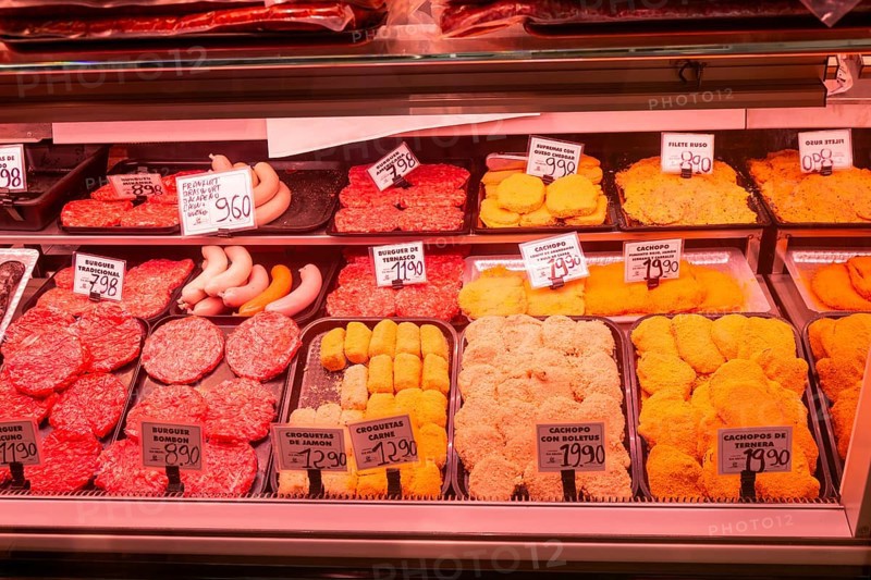 Market stall shop store selling butcher meat products inside Mercado Central de Zaragoza, Zaragoza, Aragon, Spain