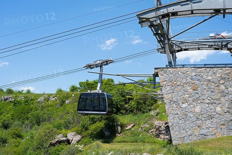Close-up of a cable car gondola surrounded by nature and under clear skies, Tatev cable car, Wings of Tatev, cable car station, Halidzor, Syunik province, Caucasus, Armenia