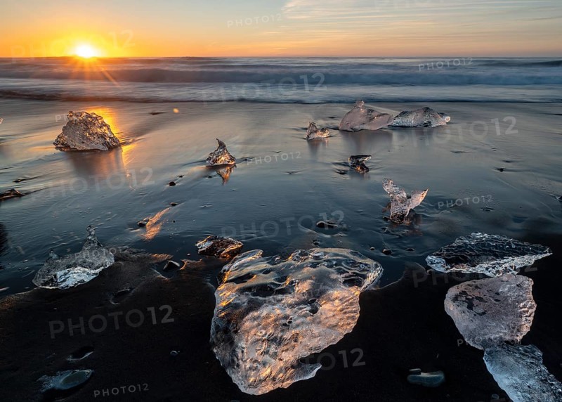 Beach with waves, ice formations, rising sun, Diamont Beach, Jökulsarlon, Iceland