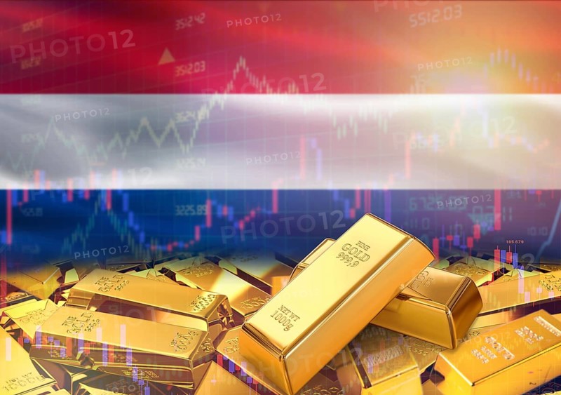 Gold bars on Netherlands flag in background. Gold bars stacked on Dutch flag. Concept of Netherlands gold reserves