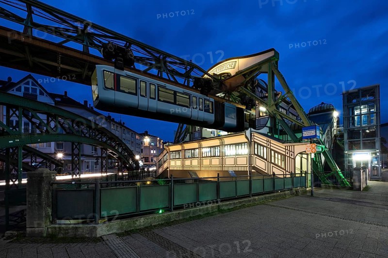 The Wuppertal suspension railway goes to the Werther Brücke stop, Wuppertal, Germany at blue hour, digitally reworked