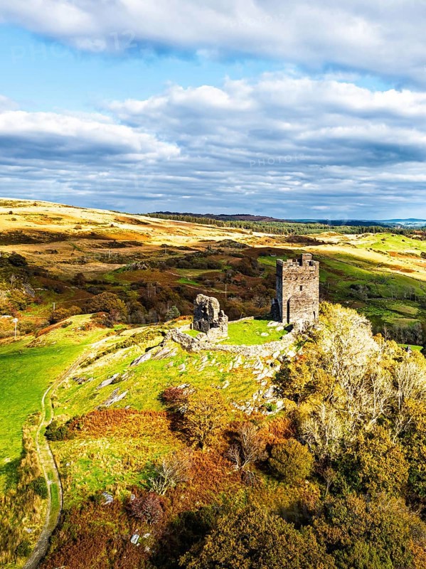 Autumn colours over Castell Dolwyddelan and Eryri Mountains from a drone, Snowdonia, Conwy County Borough, Wales, England, United Kingdom