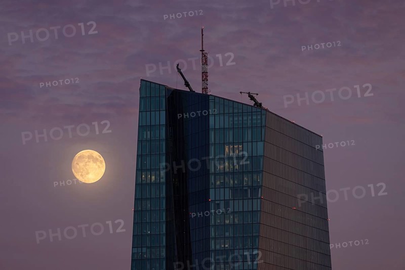 The full moon passes by the European Central Bank (ECB) in Frankfurt am Main in the evening, Frankfurt, Hesse, Germany