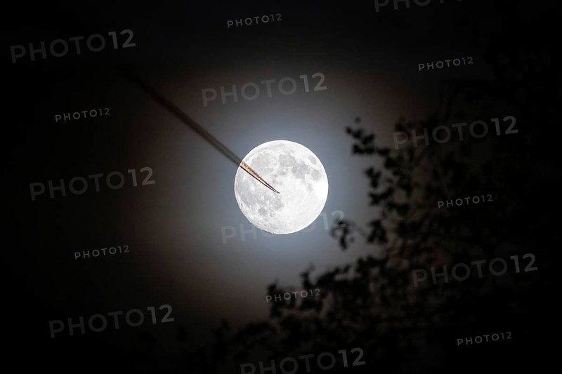 An airplane flies by in front of the full moon, Frankfurt, Hesse, Germany