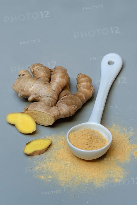 Ginger root and ginger powder in spoon, Zingiber officinale