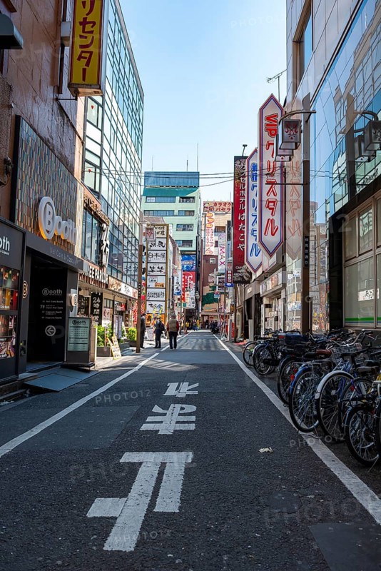 Street scene, lots of colorful signs of shops, restaurants and bars in a street, Shinjuku City, Tokyo, Japan