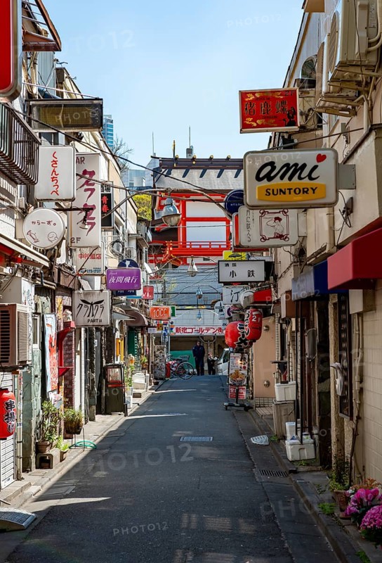 Lots of colorful signs of shops, restaurants and bars in a small alley, Shinjuku City, Tokyo, Japan