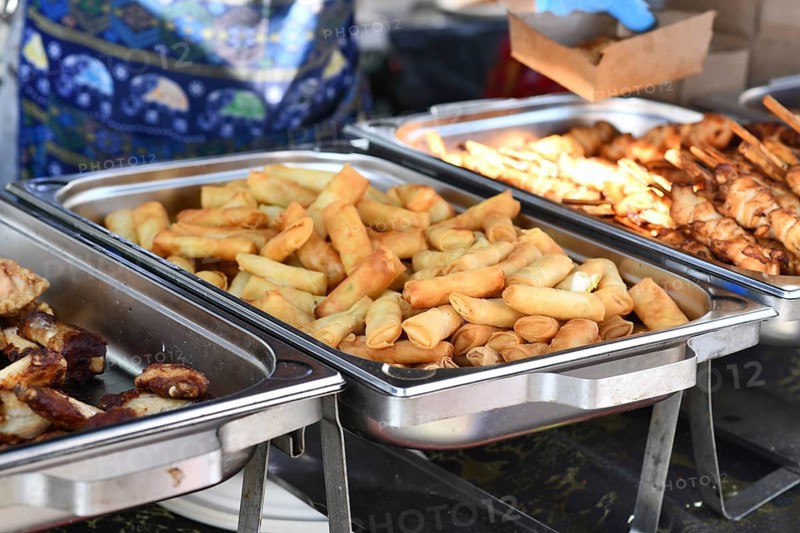 Fresh fried Thai spring rolls street food in chafing dish