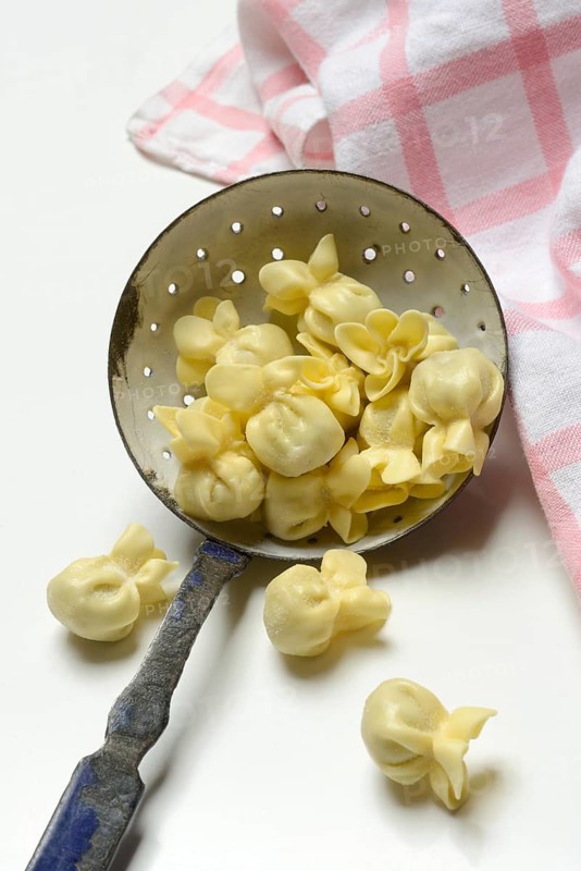 Saccottini, type of Italian pasta in a sieve ladle, pasta from Italy
