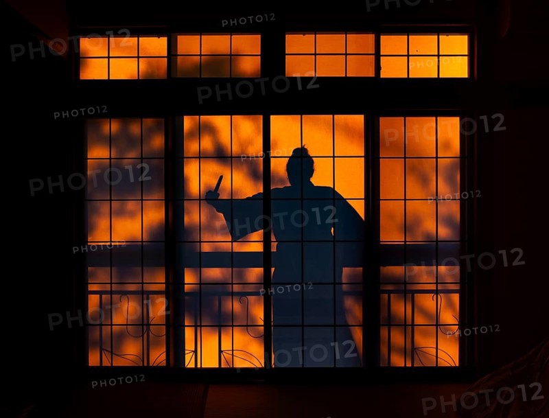 Shadow of a woman, burglar with knife, assassin, ninja, on the balcony behind a sliding shoji door in a traditional Japanese house, Yamanouchi, Nagano, Japan