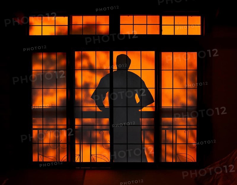 Shadows of a man in kimono, on the balcony behind sliding shoji doors in a traditional Japanese house, Yamanouchi, Nagano, Japan