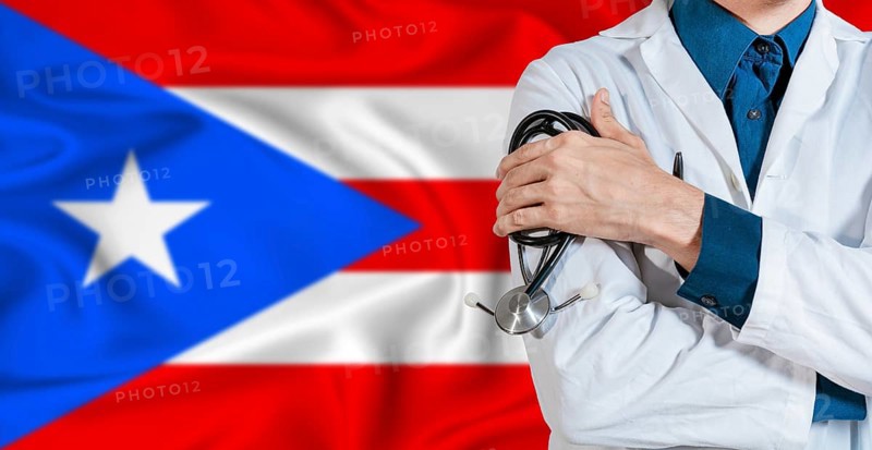 Puerto Rican healthcare concept. Doctor with stethoscope on Puerto Rico flag. Doctor holding stethoscope on Puerto Rican flag