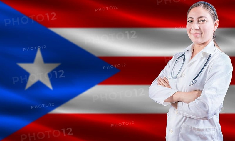Female doctor on Puerto Rico flag. Doctor with crossed arms on Puerto Rico flag. Puerto Rican health and care concept