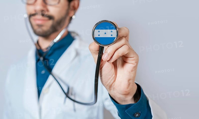Doctor holding stethoscope with Honduras flag. Honduras health and care concept. Honduras flag on stethoscope