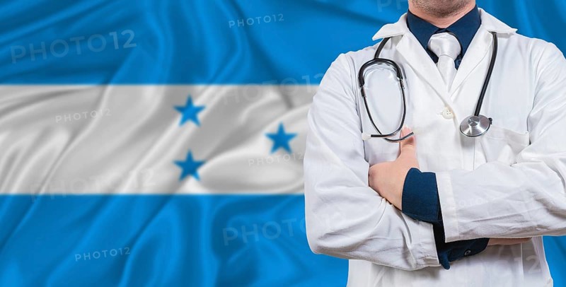 Male doctor with stethoscope on Honduras flag. Doctor holding stethoscope on Honduras flag