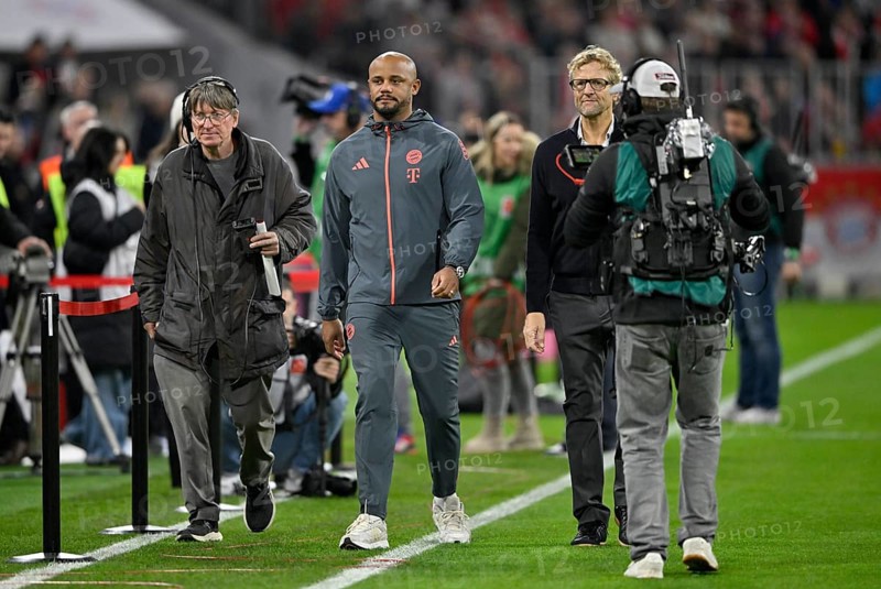 Coach coach Vincent Kompany FC Bayern Munich FCB on his way to an interview with press chief Dieter Nickles followed by Allianz Arena TV camera, Munich, Bayern, Germany