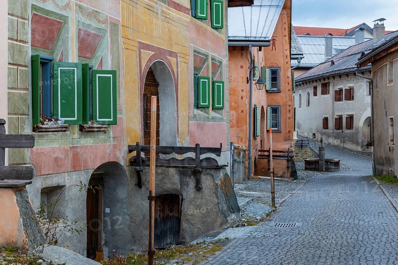 Engadin houses, historic houses, Dorstrasse with stones, village fountain, Guarda, Engadin, Grisons, Switzerland