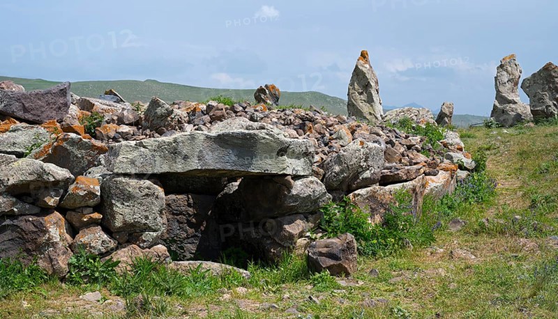 Stone wall with stones stacked on it in a green landscape, stone circle, megaliths, Zorats Karer, Karahundsch, Bronze Age burial ground, Sisian, Sisian, Sjunik province, historic Sangesur, Armenia