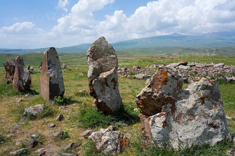 Set of stones in a vast landscape with mountains and clouds in the background, stone circle, megaliths, Zorats Karer, Karahundsch, Bronze Age burial ground, Sisian, Sisian, Syunik province, historical Sangesur, Armenia