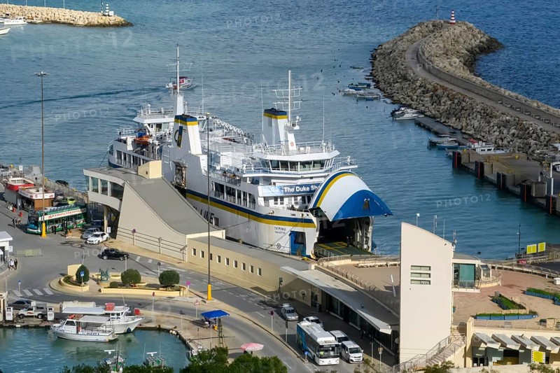 Car ferry with roll-on roll-off RoRo method for ship with two flaps for entry exit for ferry traffic between the island of Malta and the island of Gozo is located with the flap open in Mgarr Port, Gozo Malta