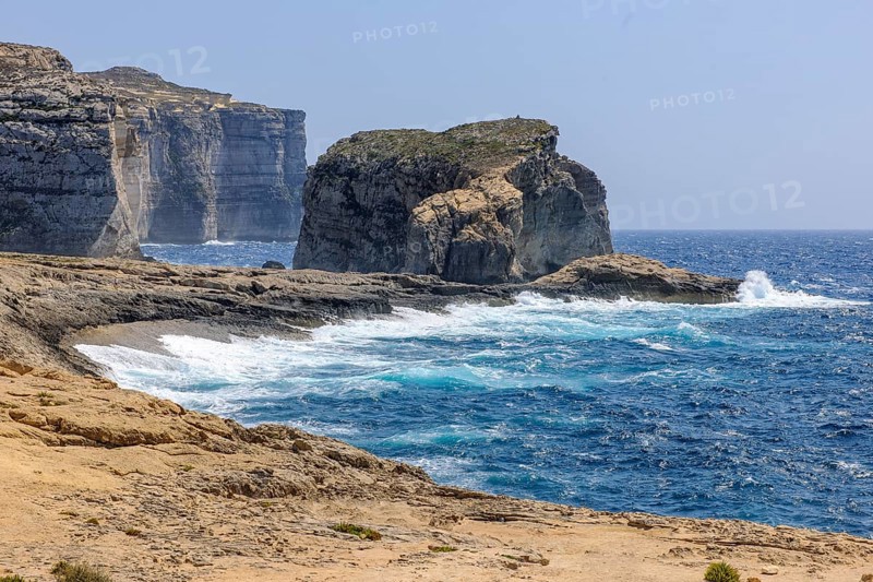 Rough rough sea surf during autumn storm high rugged cliffs burn on beach coast on the Mediterranean Sea of Gozo Island, Gozo, Malta