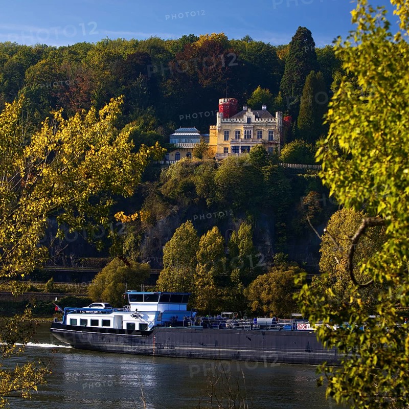 Marienfels Castle with cargo ship on the Rhine River, former residence of entertainer Thomas Gottschalk, Remagen, Rhineland-Palatinate, Germany