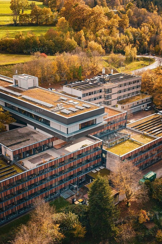 Modern buildings with green roofs in the midst of an autumn landscape, Calw District Office, Calw, Germany