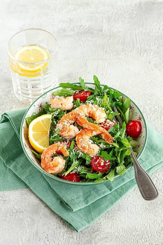 Shrimp salad with arugula and cherry tomatoes, with parmesan cheese, healthy food
