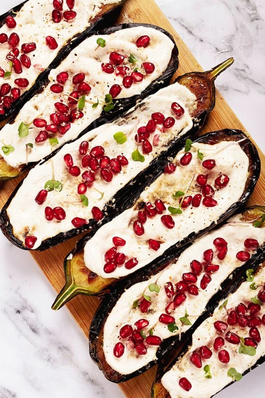 Fried eggplant with sauce, decorated with microgreens and pomegranate seeds, eggplant appetizer, top view, homemade, no people