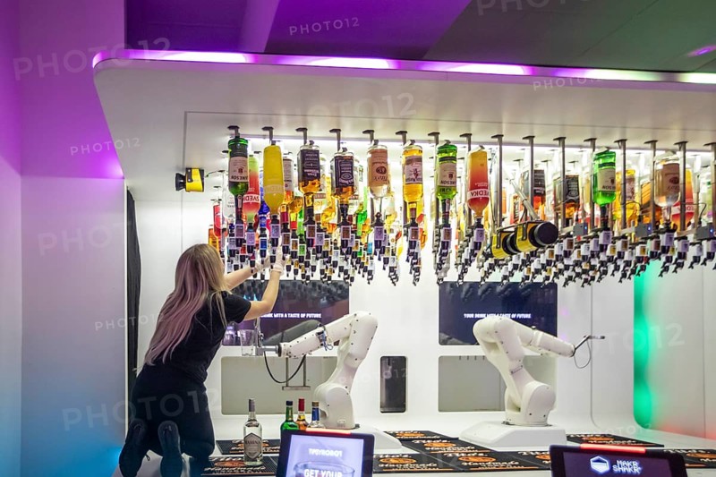 Las Vegas, Nevada - Robotic bartenders mix and serve drinks at the 'Tipsy Robot' in the Venetian Resort. A real person replaces empty liquor bottles