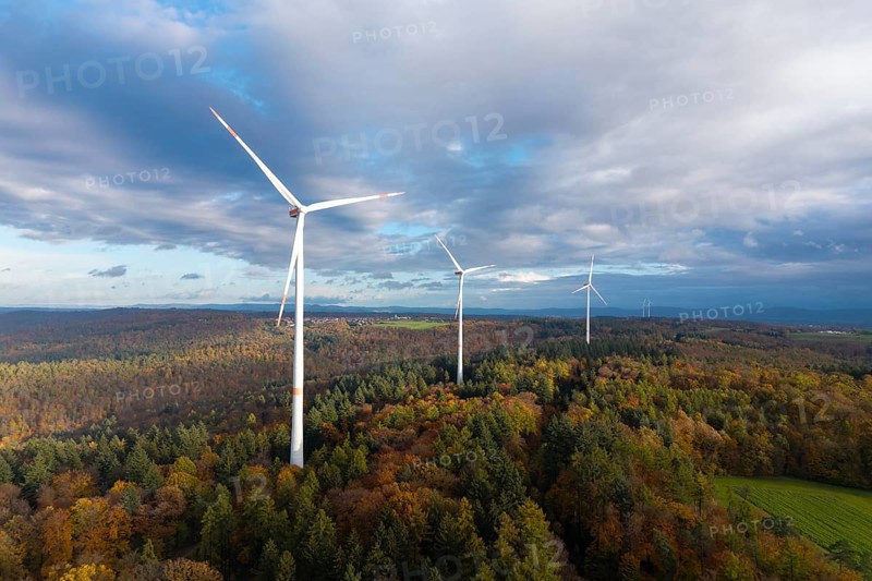 Wind turbines tower above an autumnal forest under a cloudy sky, near Schorndorf, Remstal, Rems-Murr-Kreis, Baden-Württemberg, Germany