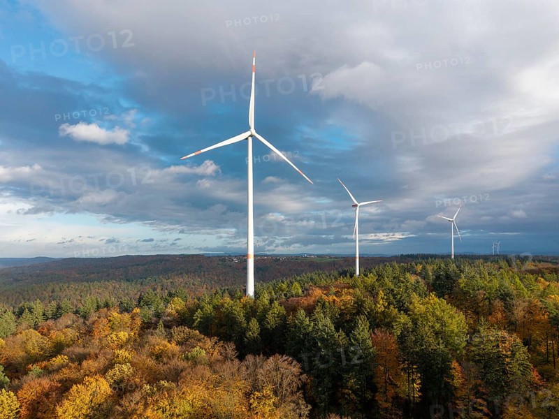 Three wind turbines above an autumnal forest against a cloudy sky, near Schorndorf, Remstal, Rems-Murr-Kreis, Baden-Württemberg, Germany