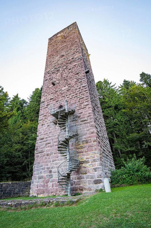 A tall stone tower with spiral staircase in the middle of a wooded area at dusk, Mandelberg Castle Ruins, Pfalzgrafenweiler, Freudenstadt District, Germany
