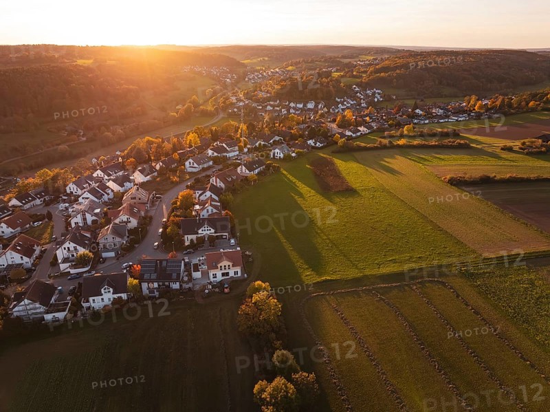 Wide view of a village on a sunny autumn evening with fields and hills, Deufringen, Aidlingen, Böblingen district, Germany