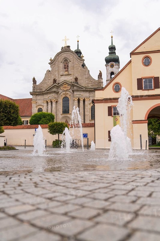 Historic church with fountain in the foreground, baroque architecture and cobblestones, ZFP Zwiefalten, Reutlingen district, Germany