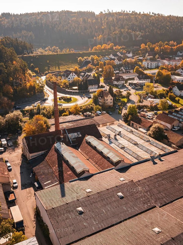 Aerial view of an industrial site in autumn with old buildings and trees, Nagold, Black Forest, Germany