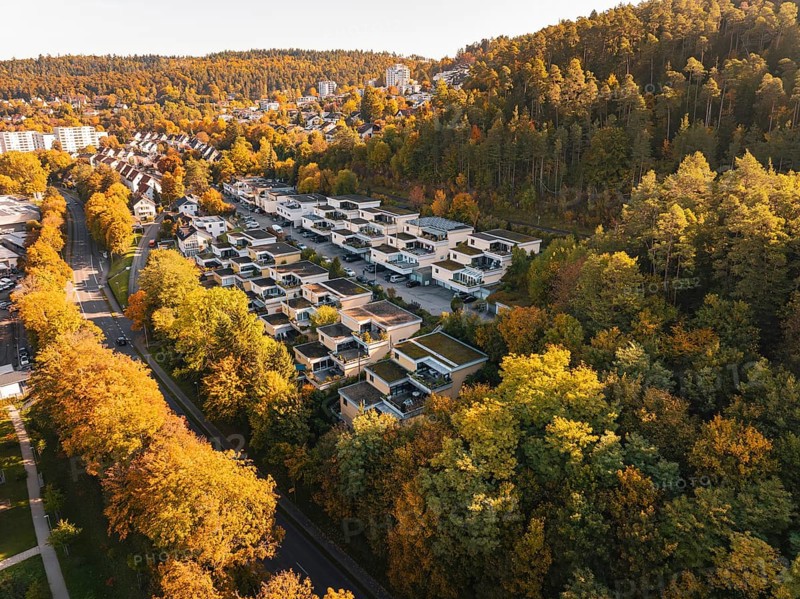 Aerial view of a residential area on the edge of a forest in autumn with intense colors, Nagold, Black Forest, Germany
