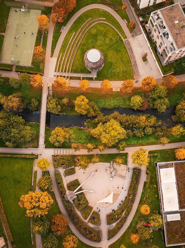 Viaduct leads through an urban area with houses and autumn trees, near a skate park, Nagold, Black Forest, Germany