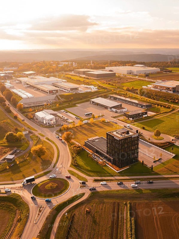 Roundabout and industrial park, in golden evening light, surrounded by fields and nature, Nagold, Black Forest, Germany