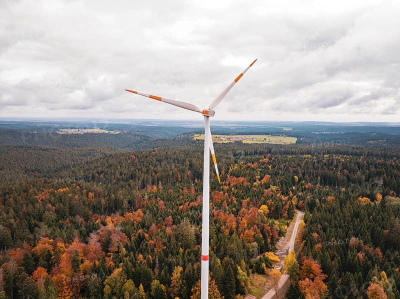 Wind turbine above a forest in autumn colors, with a wide view, Simmersfeld wind farm, Germany