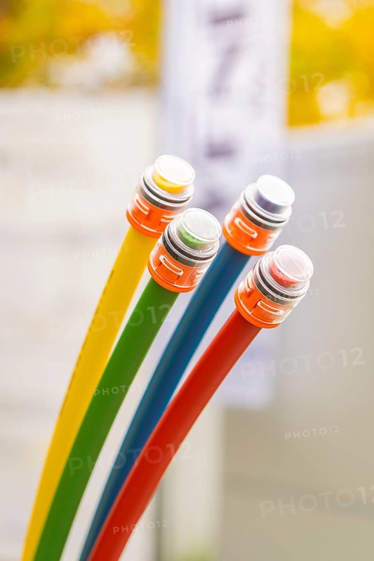 Four colored fiber optic cables in a blurred background, optical fiber