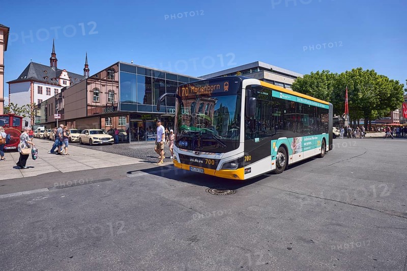 Commercial building, general architecture, modern building, perfumery, Douglas, public bus, bus line 70 Marienborn, pedestrians as accessories, trees, blue sky, cloudless, intersection of Gutenbergplatz with Schöfferstraße and Höfchen, Mainz, state capital, district-free city, Rhineland-Palatinate, Germany
