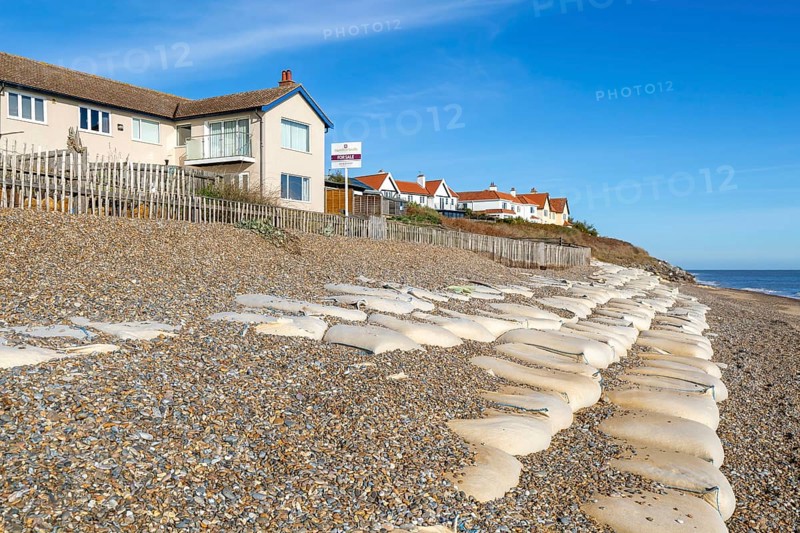 For Sale estate agent signs outside houses at risk of coastal erosion, Thorpeness, Suffolk, North Sea coast, England, UK October 2025