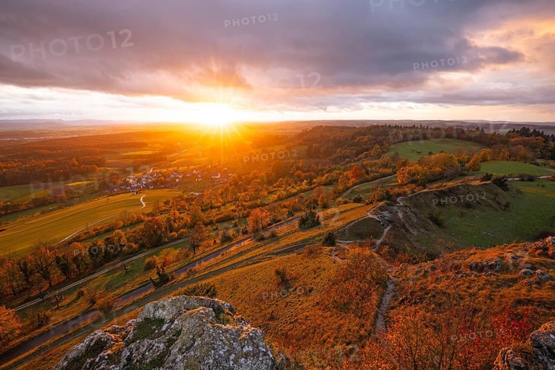 Low sun shines in the Spielburg Nature Reserve, Hohenstaufen, Göppingen, Baden-Württemberg, Germany. Indian summer over the rocks of the Swabian Jura